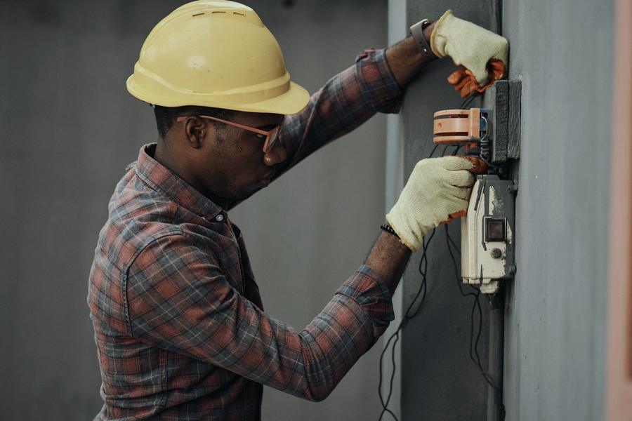 Electrician working on an electricity meter and DB board