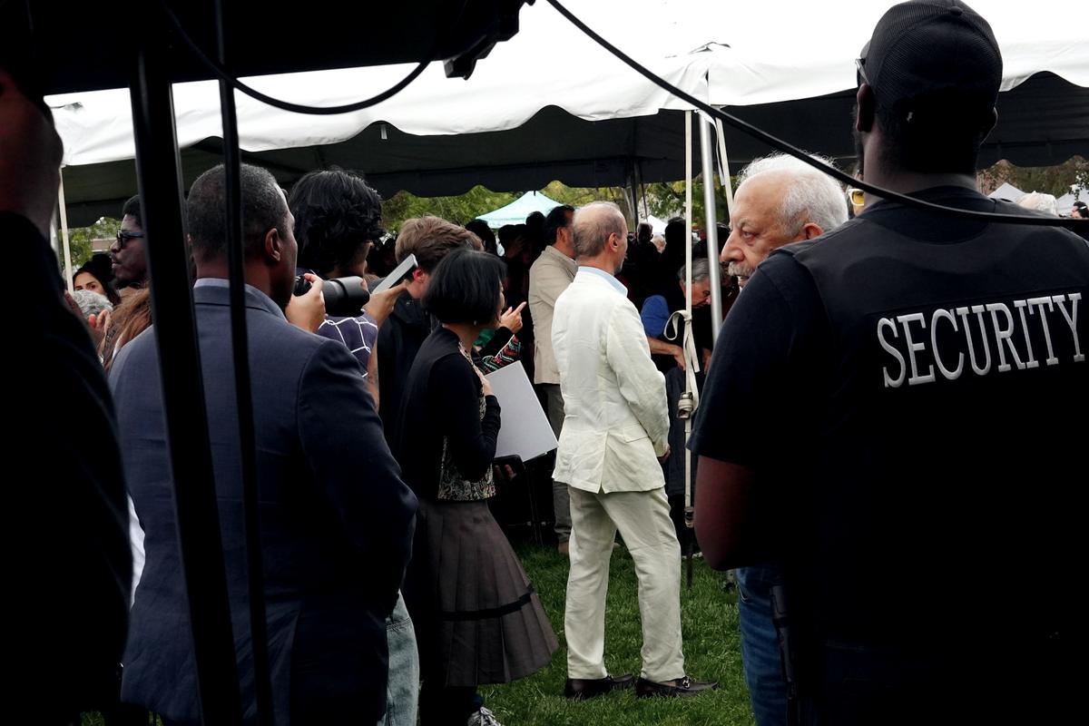 Security officer watching over an outdoor event in a marquee