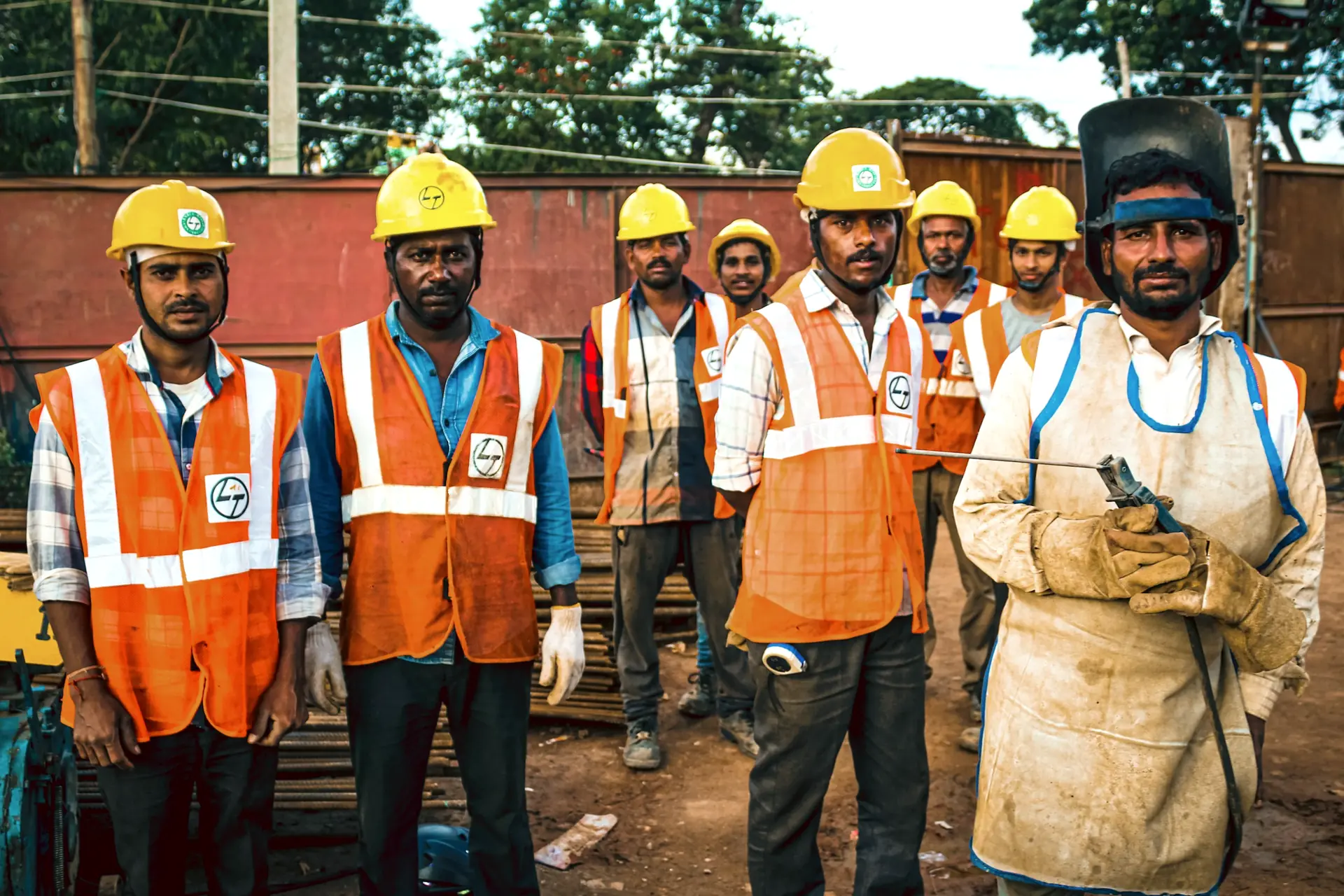 Team of workers in hard hats and safety vests