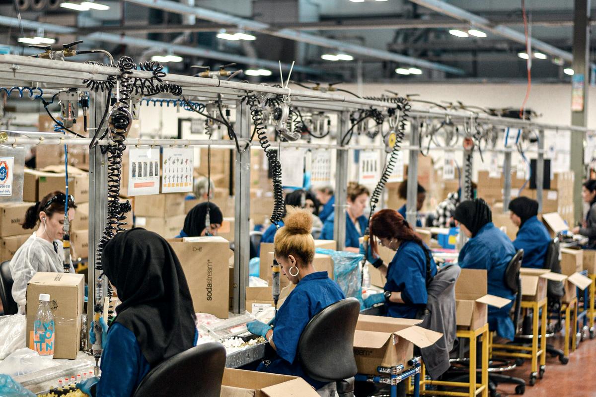 Workers on a factory assembly line