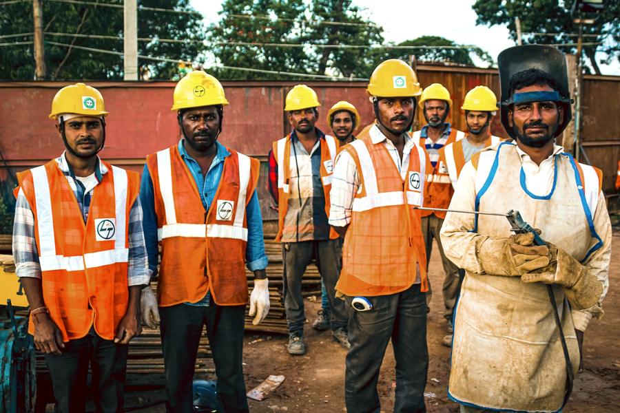 Team of workers in hard hats and safety vests
